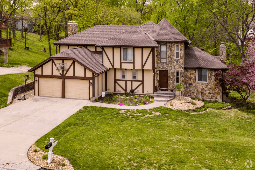 Briarcliff home exterior with stone chimney and detailed trim