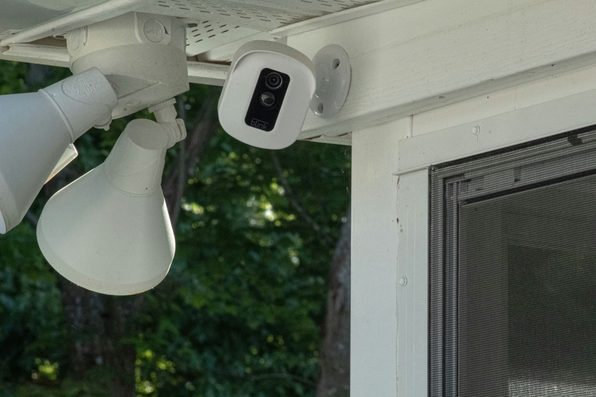 Outdoor security camera mounted beneath a home's eave