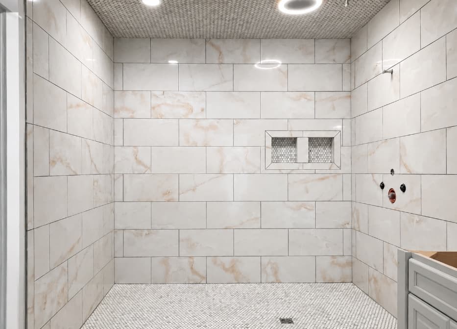Finished white tile shower with a double mosaic niche and tiled ceiling