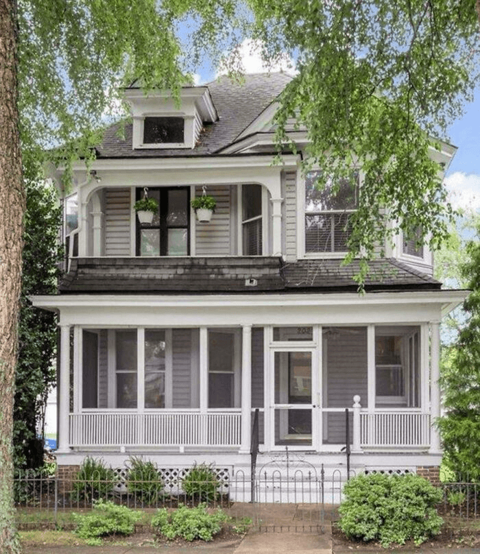 Historic Liberty home exterior with screened porches and mature trees