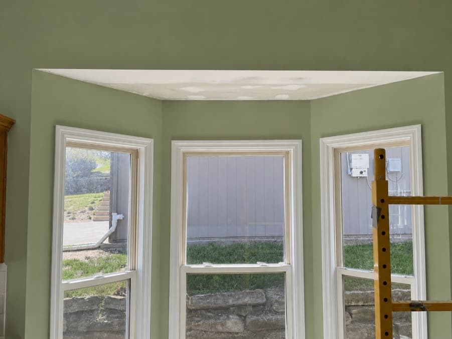 Bay window ceiling with new drywall finish in progress