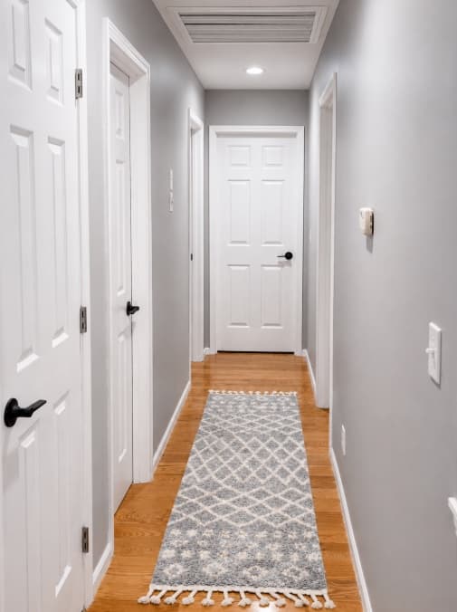Finished hallway with aligned doors and hardware