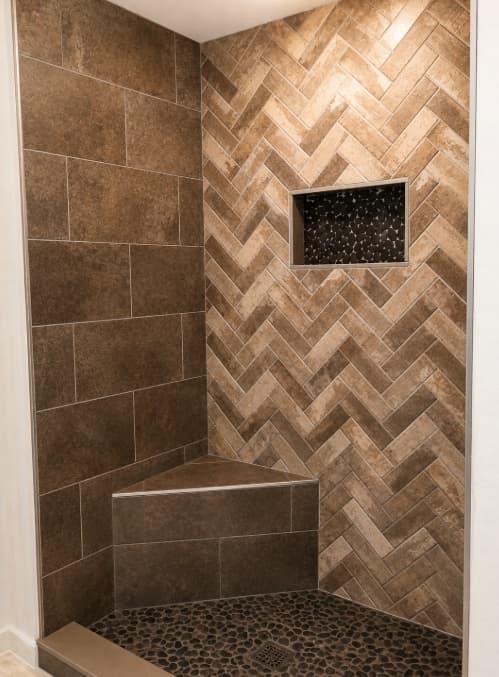 Shower with a herringbone tile feature wall and pebble floor