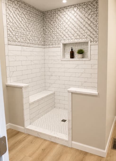 Walk-in shower with marble-look subway tile and patterned upper wall