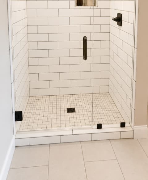 White subway tile shower with black hardware